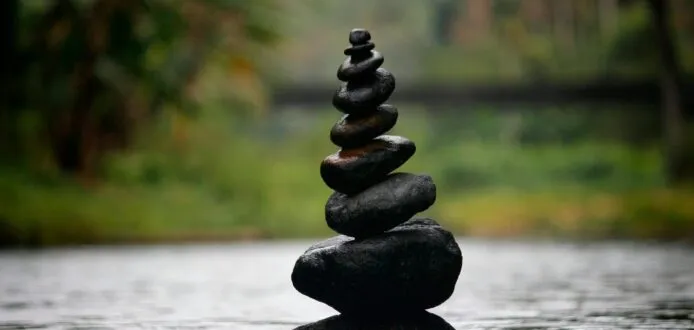 Balanced stones in water, calm natural setting